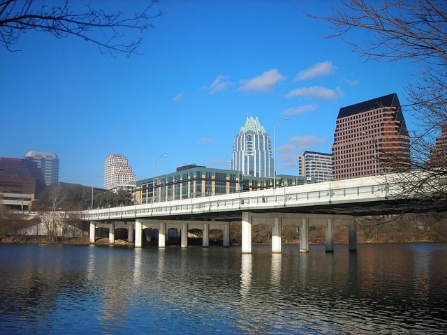 bridge and building over lady bird lake, a body of water